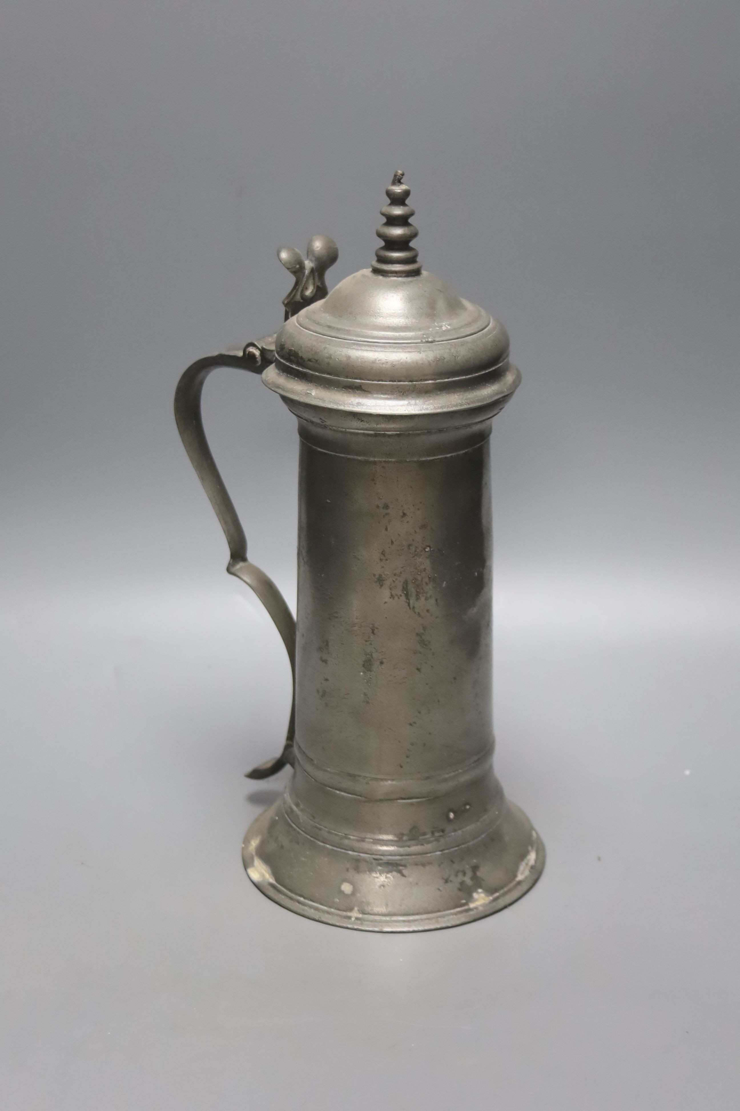 A Charles II pewter flagon, c.1675, with domed lid and turned finial and bifurcated thumbpiece, 33cm